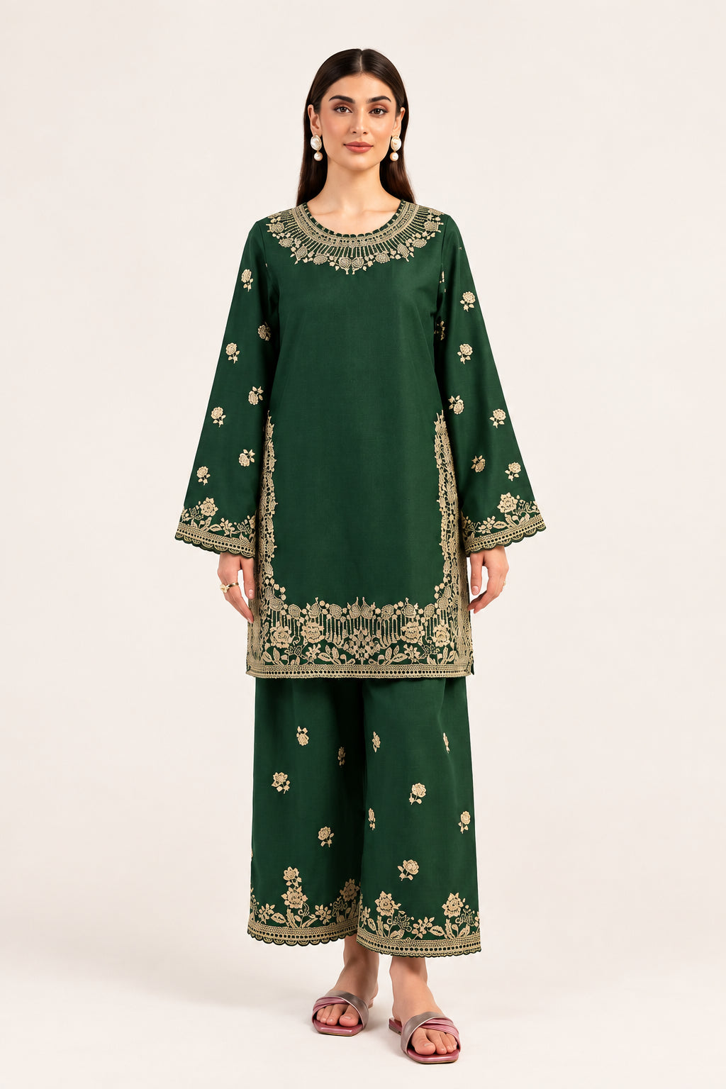 A woman modeling a dark green embroidered kurta and trouser set with beige floral patterns, set against a plain light background. The brand name 'MARYUM & MARIA' is visible in the top right corner.