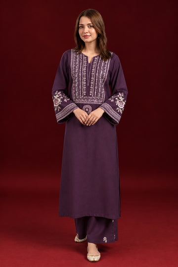 A woman modeling a deep purple long kurta with intricate white and gold embroidery on the neckline, sleeves, and center front, shown on a red studio background with two smaller inset views and the LAAM brand text.