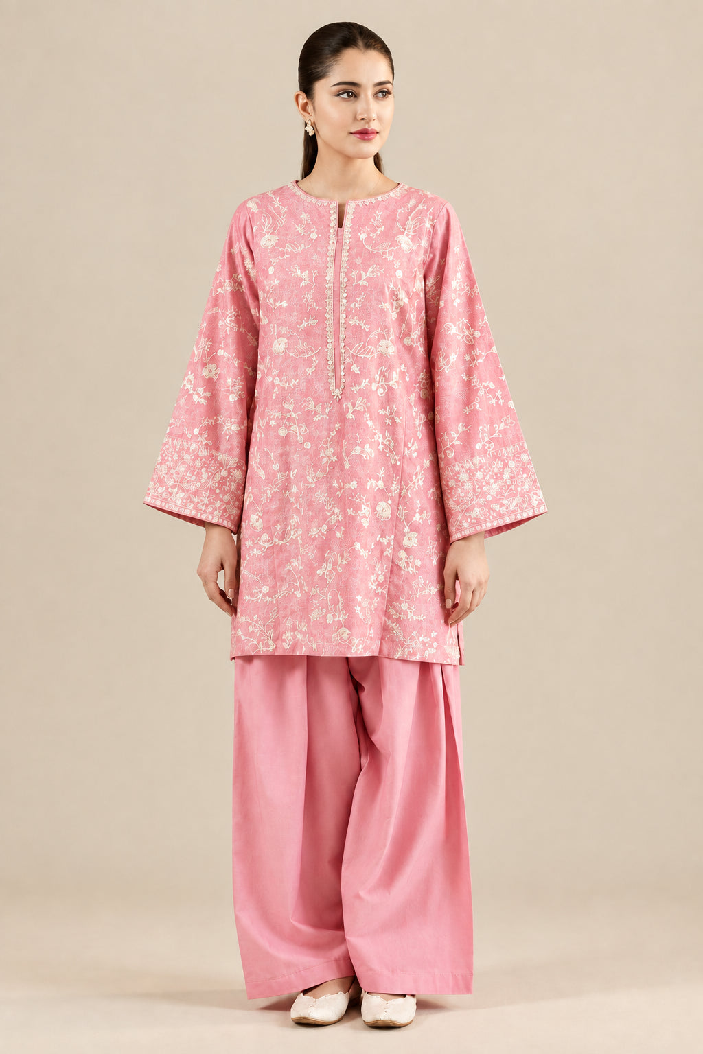A woman models a pink traditional outfit with a floral patterned kurta and matching wide-leg pants. The image includes a main full-body view, a close-up inset of the upper body, and a smaller full-body inset, all against a floral wallpaper background.