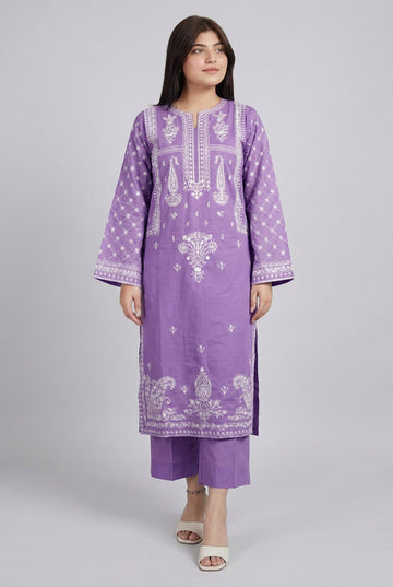 Person wearing a purple embroidered outfit standing indoors.