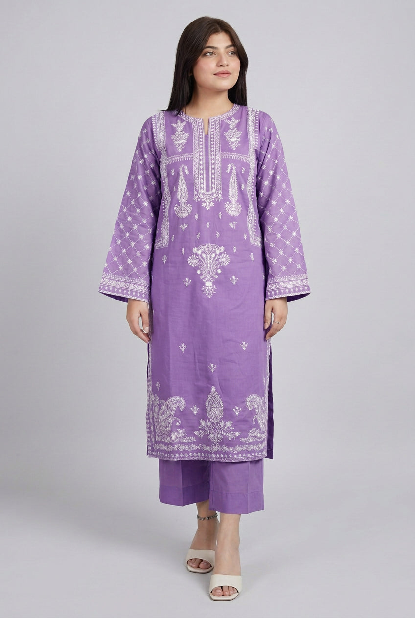 Person wearing a purple embroidered outfit standing indoors.