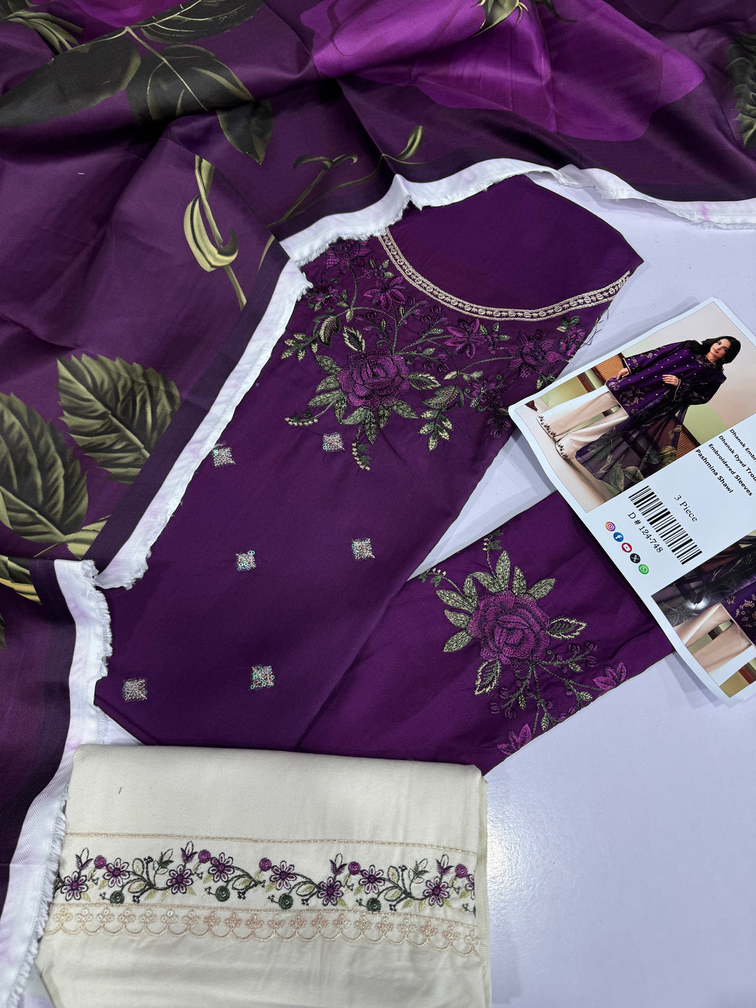 A 3-piece women's ethnic wear set from the brand AAFIN POSH, featuring a deep purple embroidered kurta, a matching purple embroidered trouser, and a sheer purple printed shawl, styled with light beige wide-leg trousers. The image is a composite layout showing the model on the left, the product details in the center, and the model again on the right.
