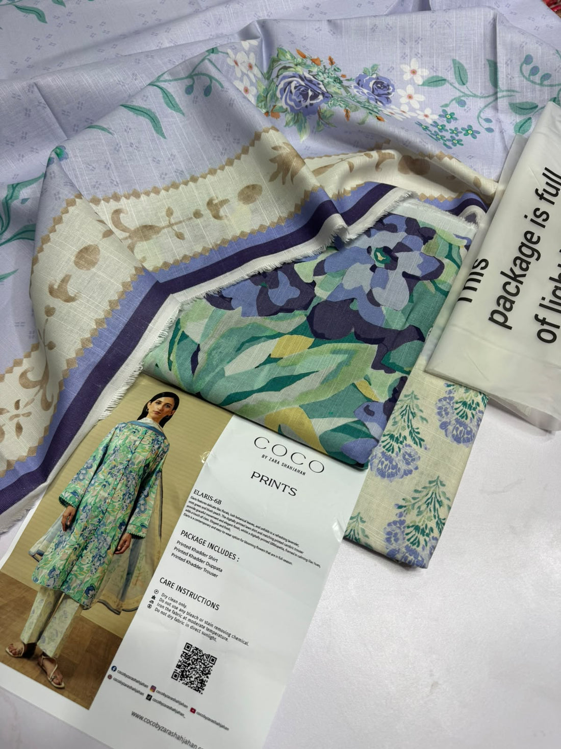 A model wearing a printed traditional kurta set stands against a beige wall on the left, with product details and text panels on the right. The set includes a light blue, green, and white floral print kurta and matching pants.