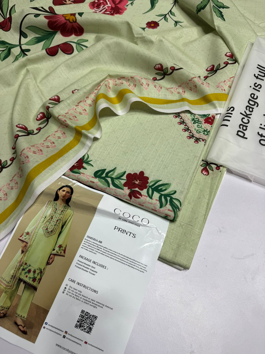 A model wearing a light green printed ethnic suit from ZARA SHAHJAHAN's Coco Prints collection, standing against a beige background next to a text panel detailing the Ismeria-88 outfit.