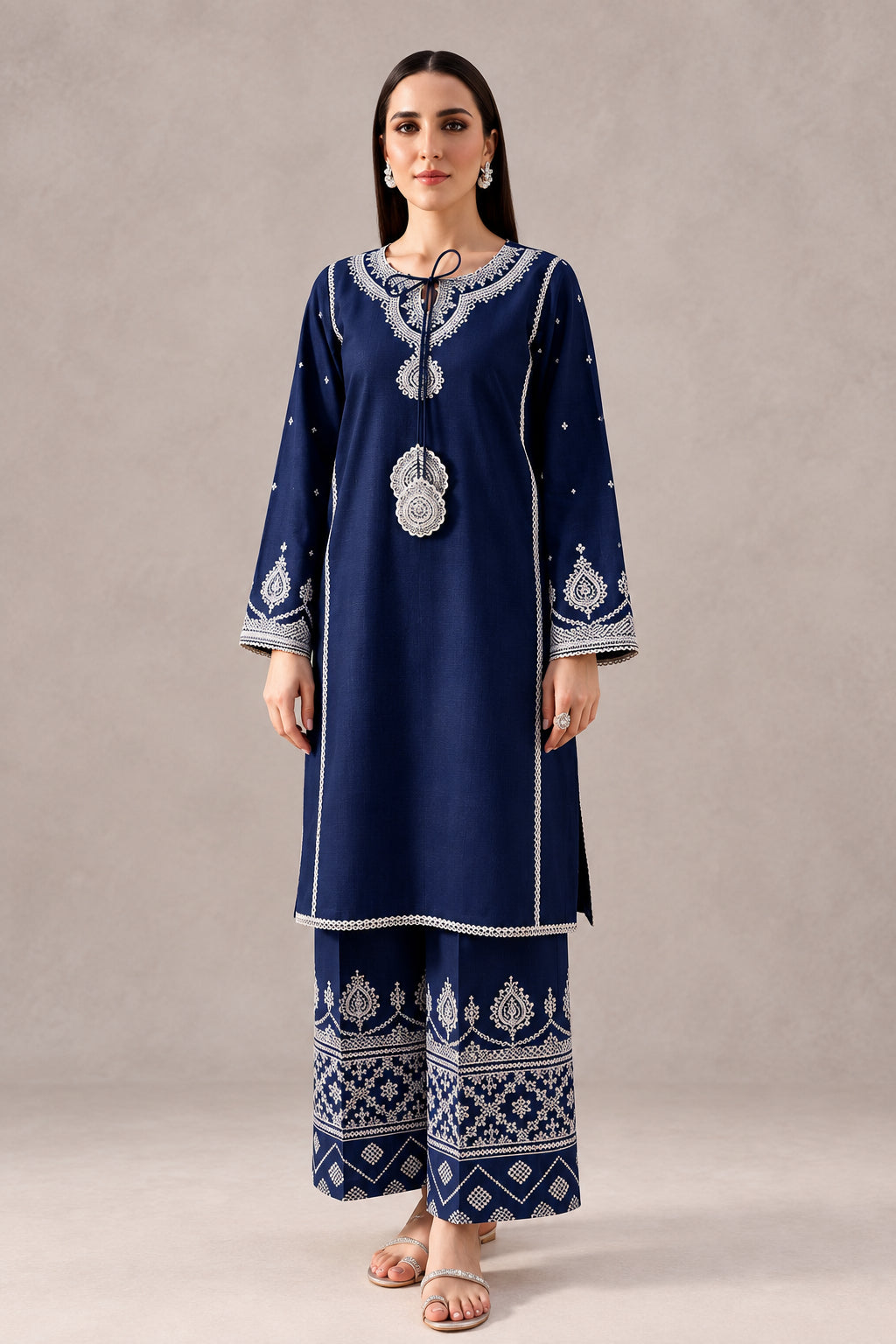 A woman models a navy blue batik kurta and trouser set with intricate white and silver embroidery, standing in a styled studio setting with wooden furniture and ceramic vases. The text 'BATIK CODE:100018' is visible in the top right corner.