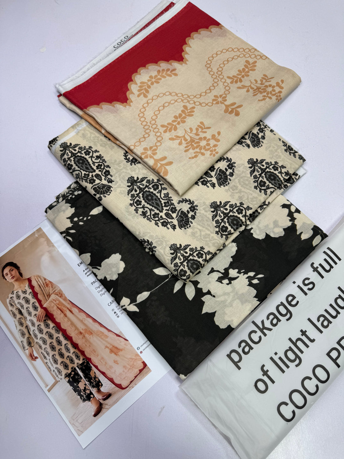 A fashion catalog page for ZARA SHAHRIHANA's COCO Prints, showing a model wearing the EMIN-10B outfit on the left, and product details on the right including a description of the botanical blue print, package contents, and care instructions.
