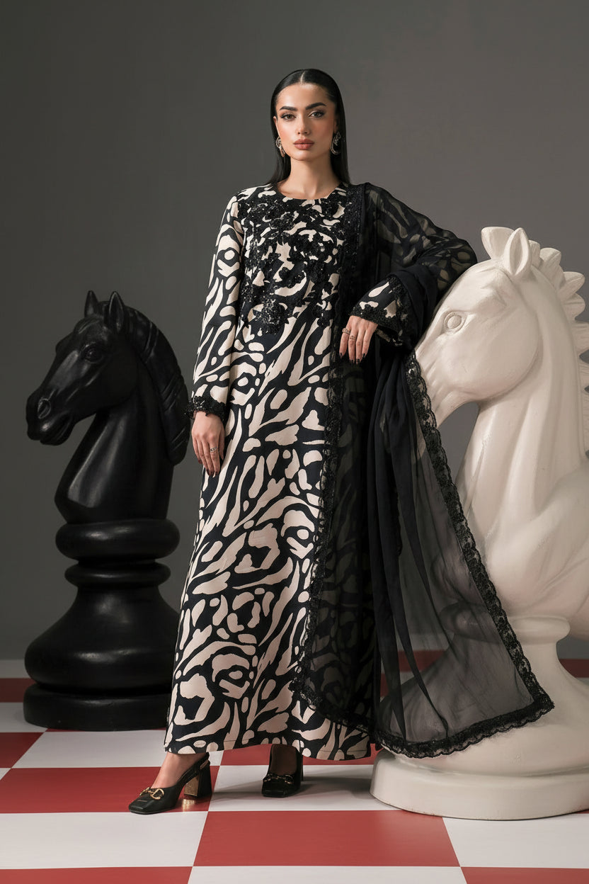 A fashion catalog composite showing a model wearing a long black and beige patterned embroidered dress or kurta set on the left, with text listing the materials and pieces on the center, and a closer view of the garment on the right. The brand name MARIA.