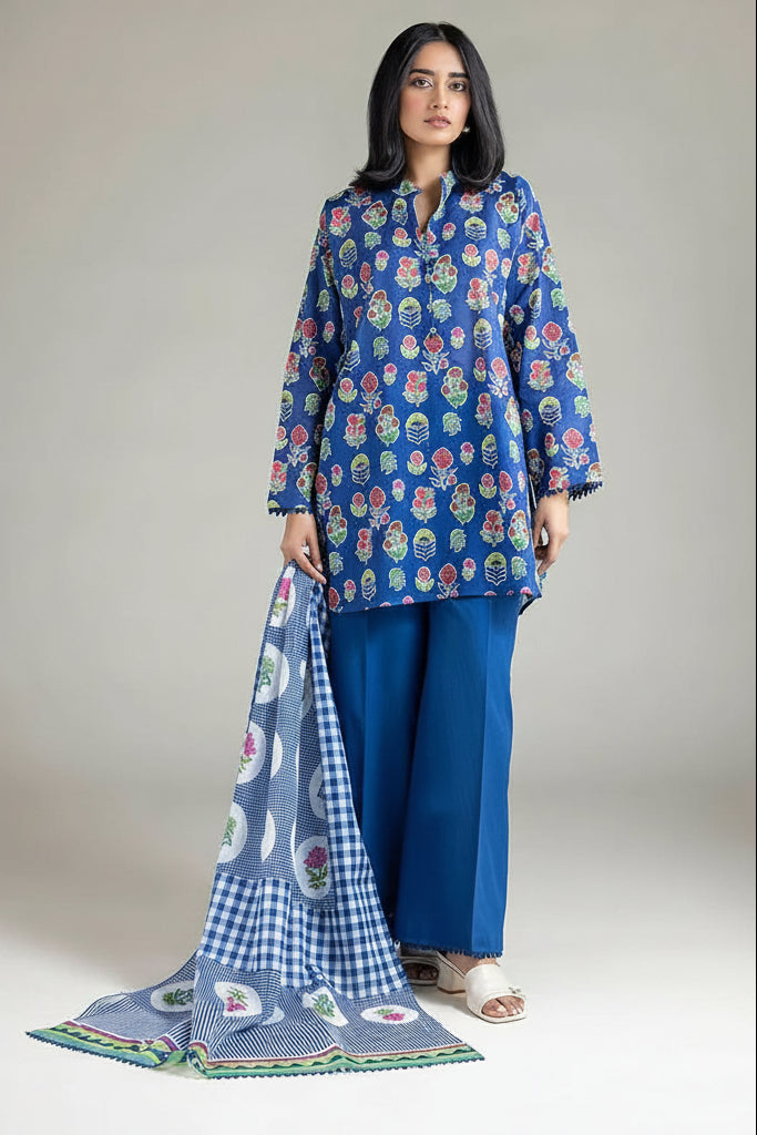 A 3-piece women's suit set from KHAADI, featuring a blue printed kurta, solid blue pants, and a blue-and-white gingham dupatta with colorful paisley borders, shown on a model against a light gray studio background with product details listed on the left.