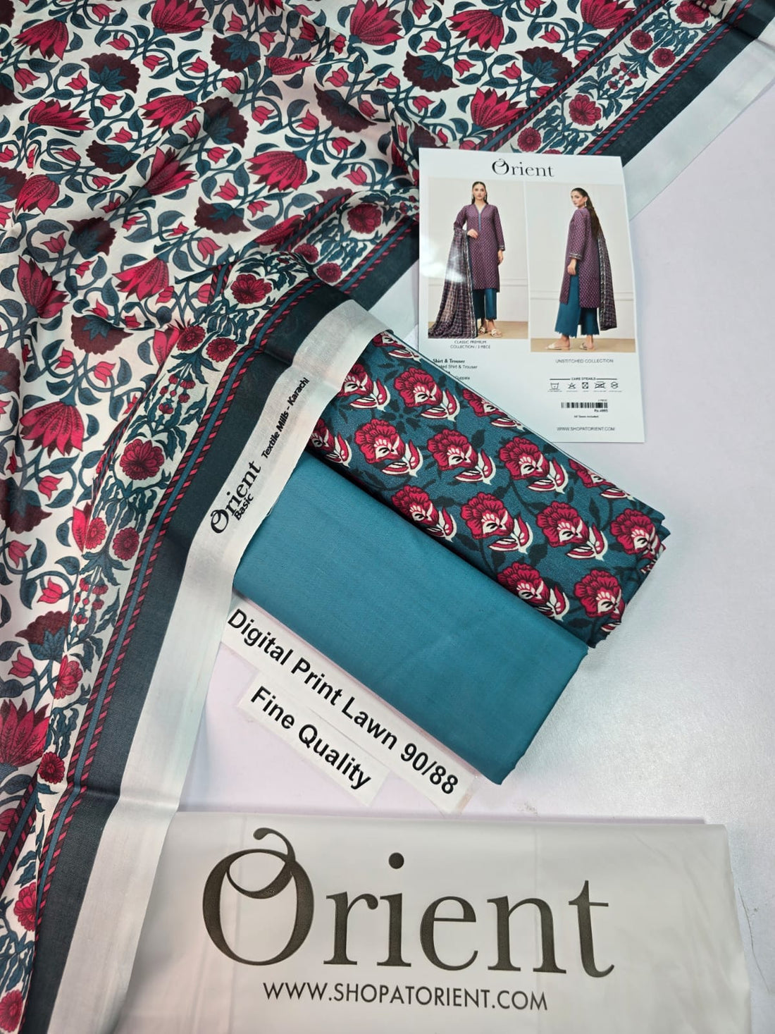 A catalog page for Orient brand women's printed shirt and trouser collection, showing two full-body views of a model wearing a purple patterned kurta with teal palazzo pants and a matching dupatta. The page includes product text, care instructions, barcode, and website information.