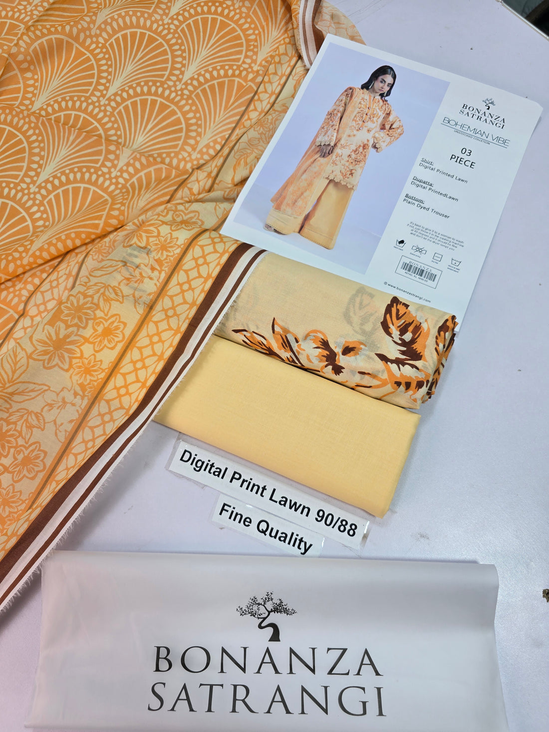 A model wearing a three-piece traditional South Asian outfit from Bonanza Satrangi's Bohemian Vibe collection, featuring a yellow printed kurta, matching trousers, and a yellow shirt. The image is split into two sections: the left shows the model, and the right contains product details, fabric descriptions, and care instructions on a white background.