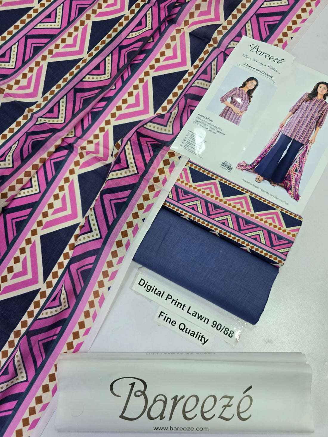 A fashion catalog page for Bareezé Lawn Premium Collection showing a woman modeling a three-piece unstitched outfit. The set includes a pink and purple patterned digital printed lawn shirt, a matching printed violette dupatta, and a dark navy wide-leg trouser.