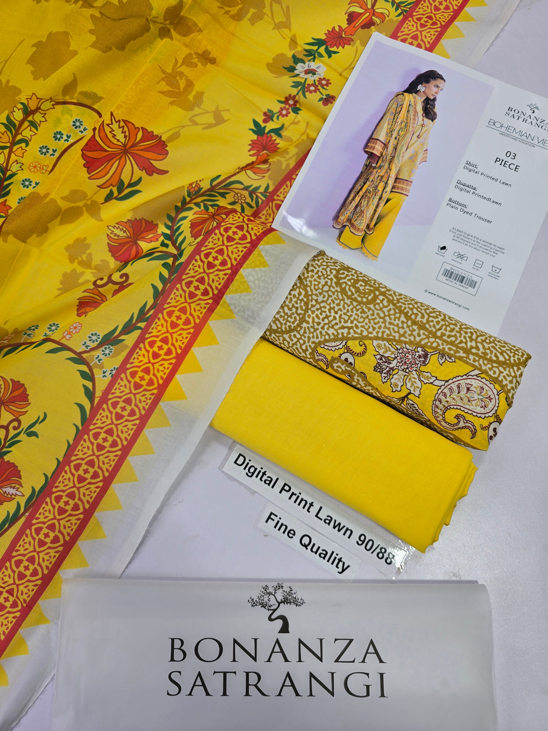 A model wearing a yellow and gold digital print three-piece traditional outfit from Bonanza Satrani's 'Bohemian Vibe' collection, shown against a light pink background with product details on the right.